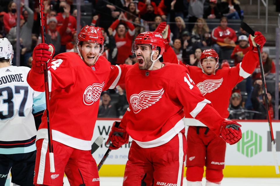 Detroit Red Wings center Robby Fabbri (14) receives congratulations from center Pius Suter (24) after scoring in the second period Dec. 1, 2021 against the Seattle Kraken at Little Caesars Arena in Detroit.