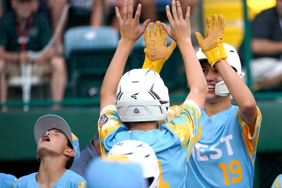 El Segundo, Calif.’s Louis Lappe (19) celebrates with teammates on the way back to the dugout after his three-run home run against Needville, Texas, during the fifth inning of the U.S. championship baseball game at the Little League World Series in South Williamsport, Pa., Saturday, Aug. 26, 2023. (AP Photo/Tom E. Puskar)