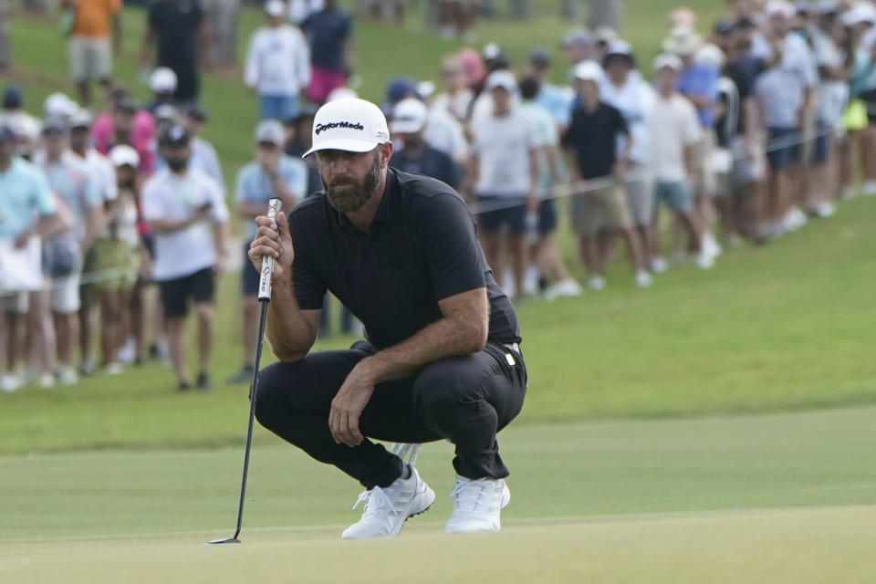 Dustin Johnson prepares to putt on the second green during the final round of the LIV Golf Team Championship at Trump National Doral Golf Club, Sunday, Oct. 30, 2022, in Doral, Fla. (AP Photo/Lynne Sladky)