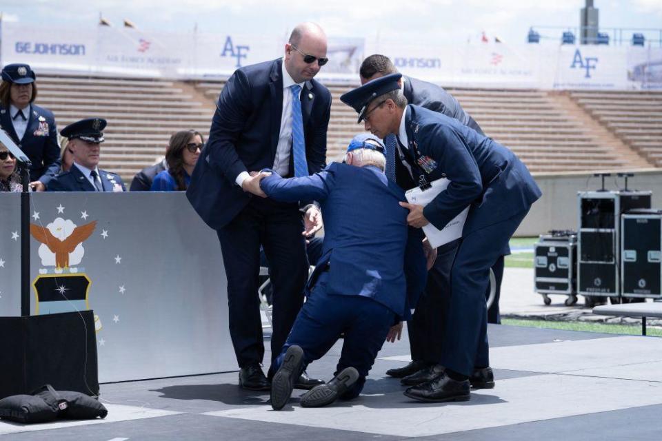 President Biden is helped up after falling during the graduation ceremony at the United States Air Force Academy, just north of Colorado Springs in El Paso County, Colorado, on June 1, 2023. / Credit: BRENDAN SMIALOWSKI/AFP via Getty Images