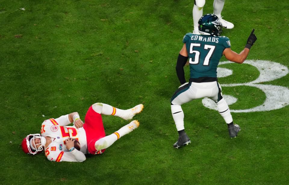 Feb 12, 2023; Glendale, AZ, USA; Kansas City Chiefs quarterback Patrick Mahomes (15) lies on the turf after being tackled by Philadelphia Eagles linebacker T.J. Edwards (57) during the second quarter in Super Bowl LVII at State Farm Stadium. Mandatory Credit: Patrick Breen/The Republic via USA TODAY Sports