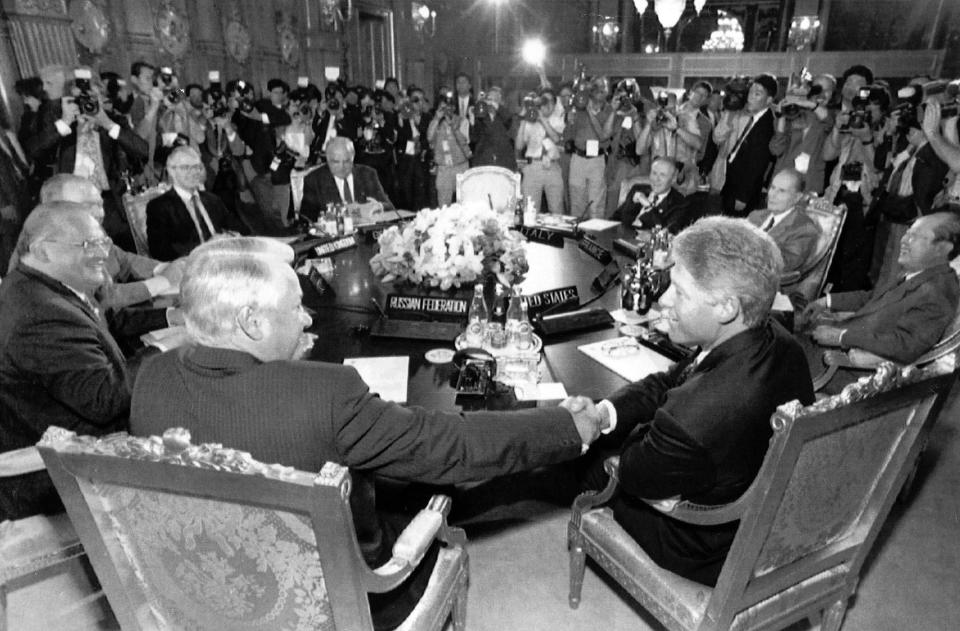 FILE - In this July 9, 1993 file photo U.S. President Bill Clinton, right, shakes hands with Russian President Boris Yeltsin prior to the meeting of the Group of Seven summit at the Akasaka Palace in Tokyo. The G-7 is an informal club of rich democracies that aim to enhance their friendship and synchronize their views. Countries take turns chairing the annual summit, which typically ends with a final statement expressing financial and political commitments. (AP-Photo/Itsuo Inouye, File)