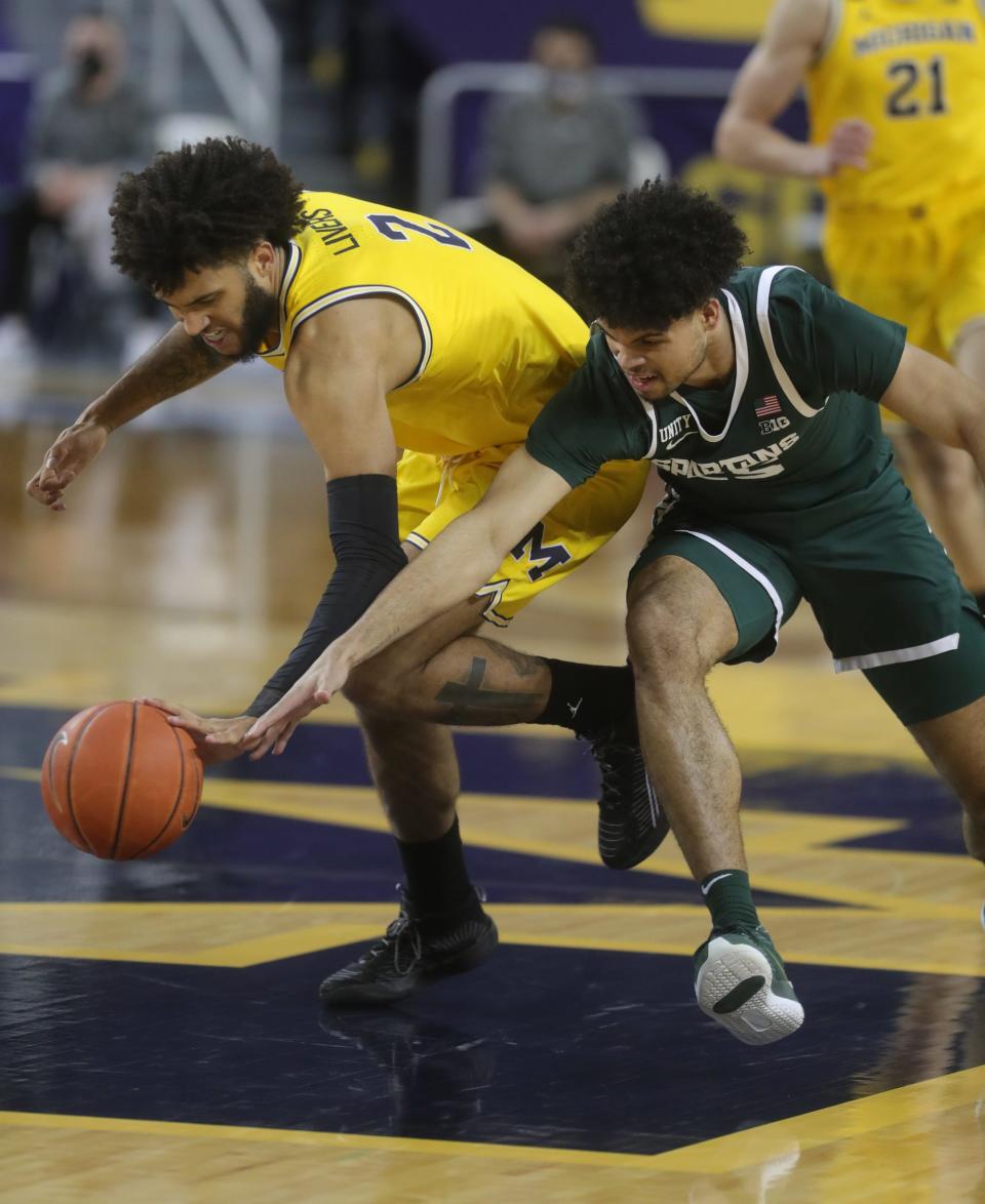 Michigan Wolverines forward Isaiah Livers defends Michigan State Spartans forward Malik Hall on Thursday, March 4, 2021 at Crisler Center in Ann Arbor.