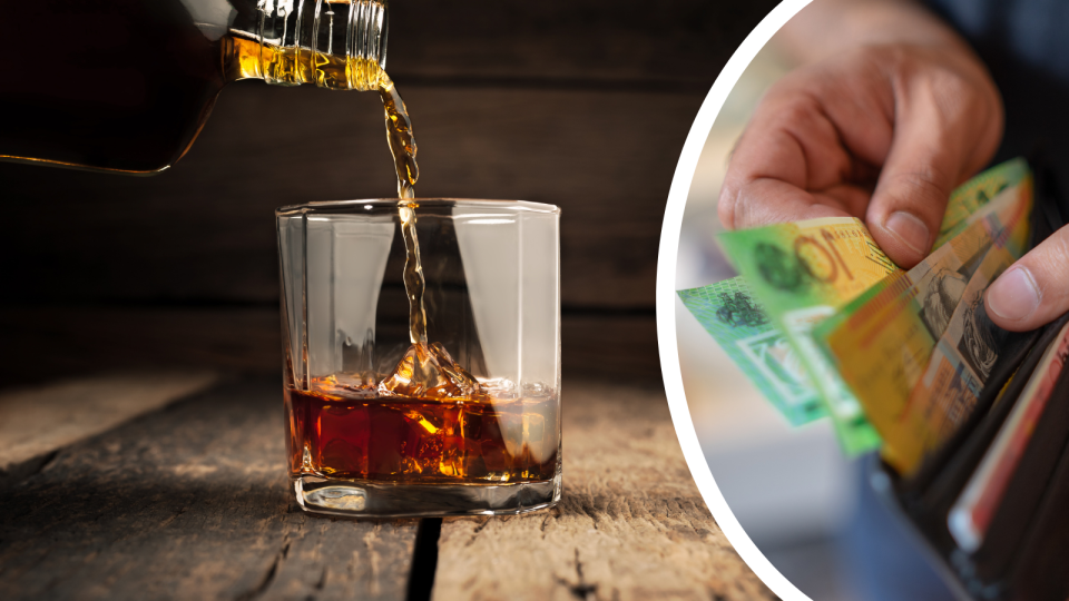 Whiskey being poured from a bottle into a glass over ice and a man removing $100 notes from a wallet.