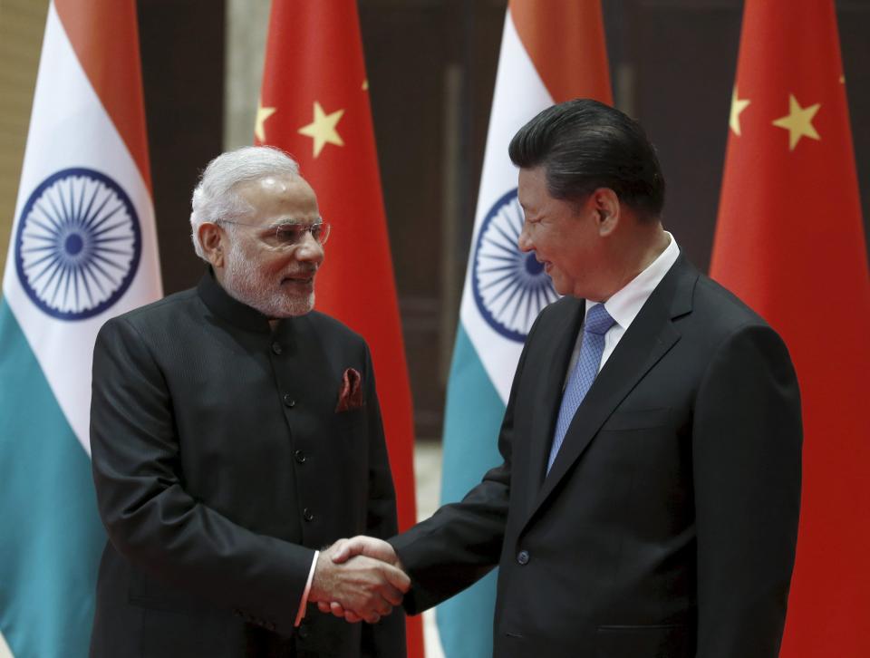 Indian Prime Minister Narendra Modi and Chinese President Xi Jinping shake hands before they hold a meeting in Xian