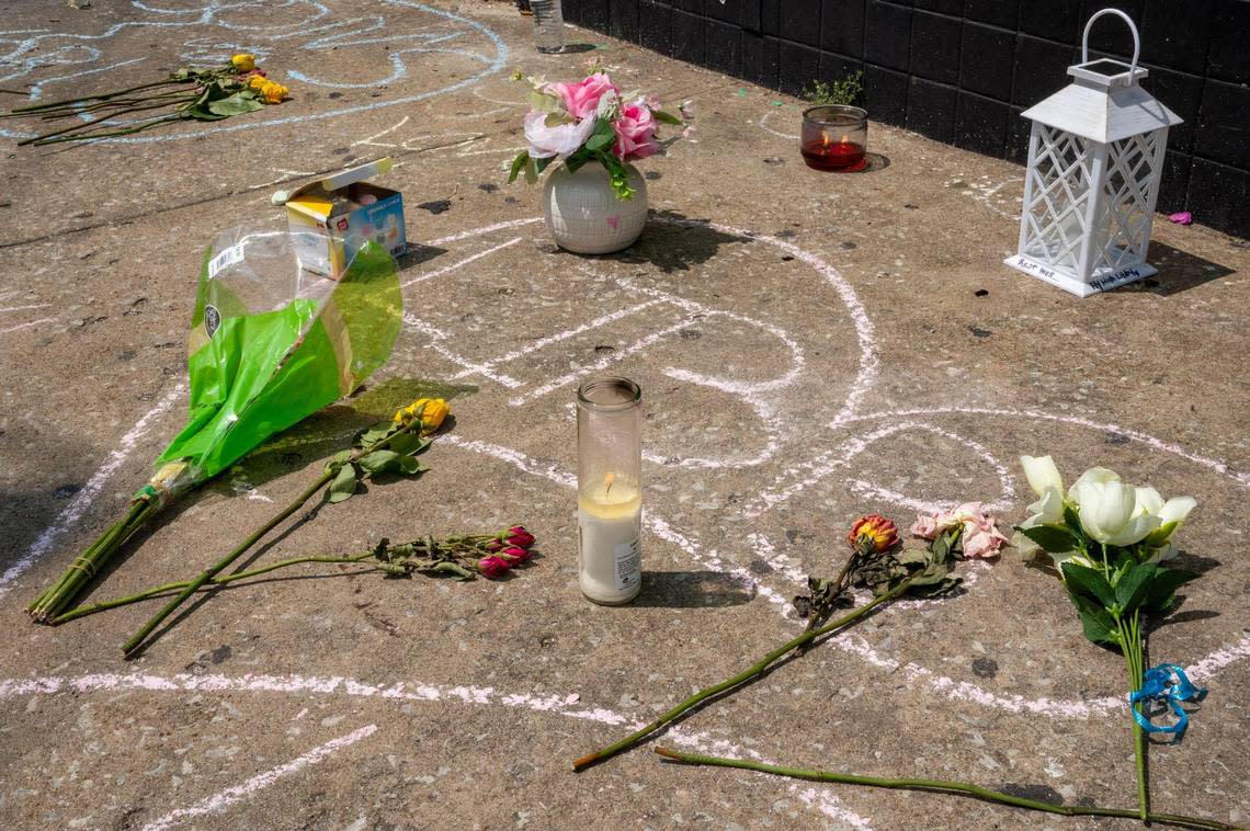 Messages written in chalk are seen on the sidewalk outside Klymax Lounge on May 22 in Kansas City. Three people were killed and two were injured in a shooting on May 21 at the nightclub.