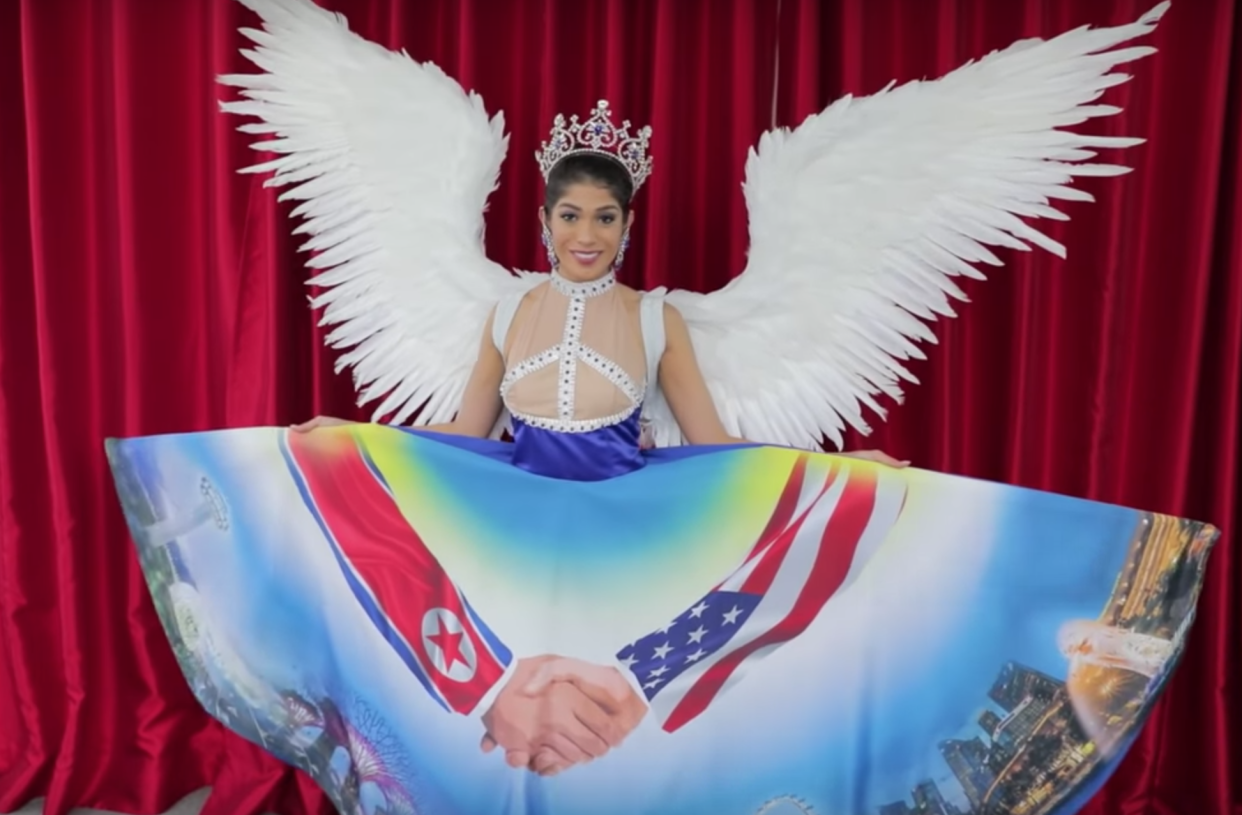 Miss Singapore revealed an unusual dress featuring Donald Trump and Kim Jong Un. (Photo: YouTube/The New Paper)
