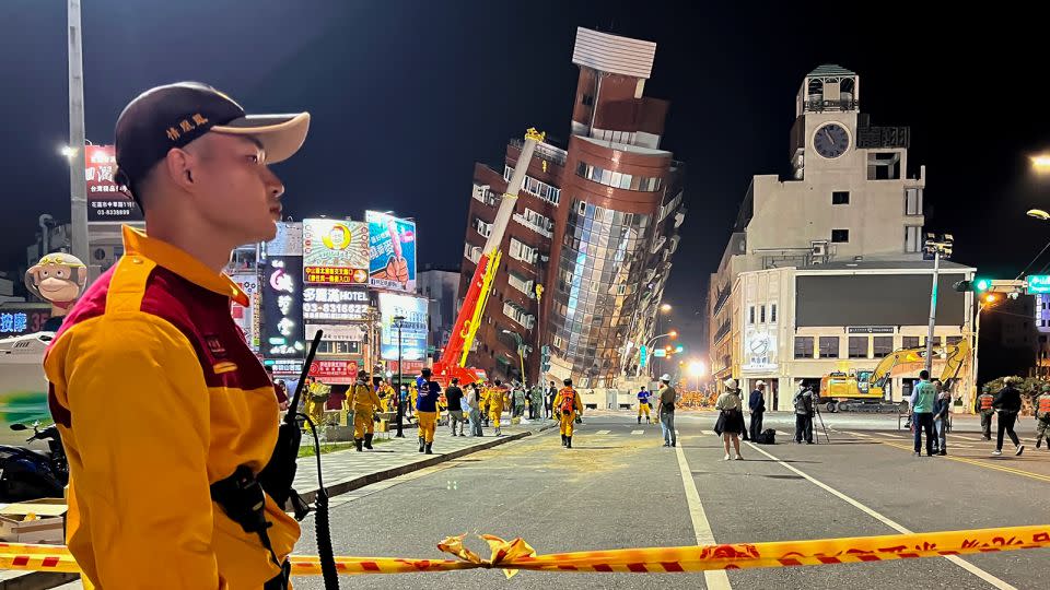 A rescue worker stands near the cordoned off site in the aftermath of an earthquake in Hualien, eastern Taiwan on Wednesday, April 3, 2024. - Johnson Lai/AP