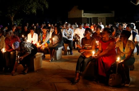 Zimbabwean healthcare workers hold a candlelight vigil to protest over the disappearance of Peter Magombeyi, the leader of their union in Harare