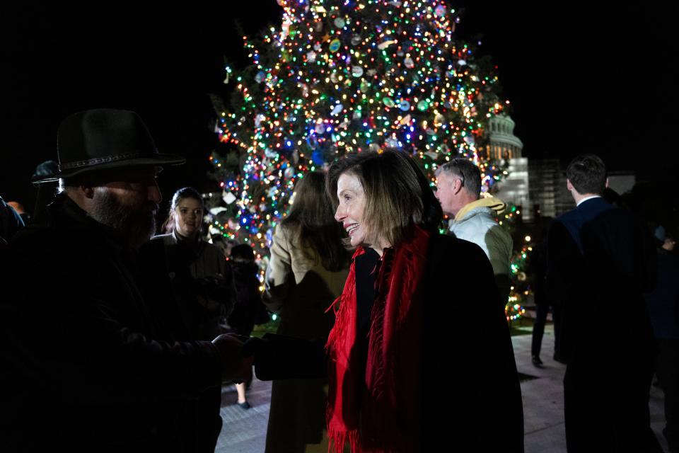 Speaker of the House Nancy Pelosi of Calif., center, greets people at the U.S. Capitol Christmas Tree Lighting Ceremony on Nov. 29. The tree came from Pisgah National Forest in western North Carolina.