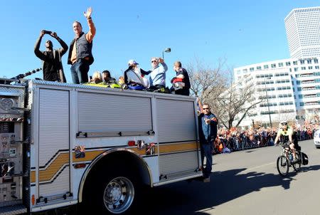 Feb 9, 2016; Denver, CO, USA; Denver Broncos outside linebacker DeMarcus Ware (left) and quarterback Peyton Manning (center) and general manager John Elway (right) wave to the crowd during the Super Bowl 50 championship parade at Civic Center Park. Mandatory Credit: Ron Chenoy-USA TODAY Sports