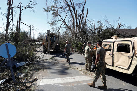 Soldiers of the Florida National Guard clear downed trees in the aftermath of Hurricane Michael in Parker, Florida, U.S., October 13, 2018. REUTERS/Terray Sylvester