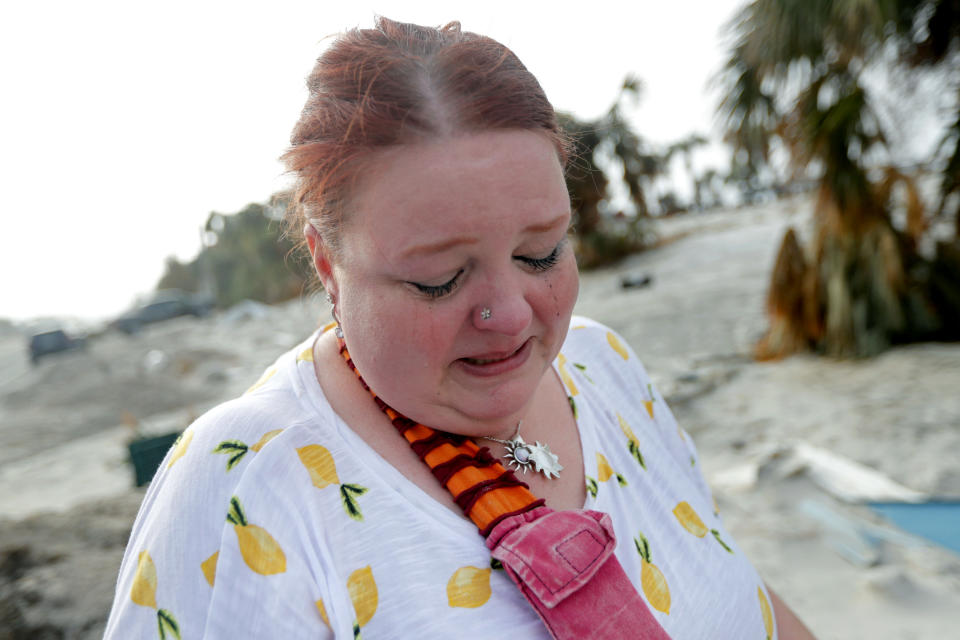 Lanie Eden cries as she looks for her family's possessions in the aftermath of Hurricane Michael in Mexico Beach, Fla., Wednesday, Oct. 17, 2018. They evacuated just before the storm. She said the family had so many cherished memories there, that it's like losing part of your family. (AP Photo/Gerald Herbert)