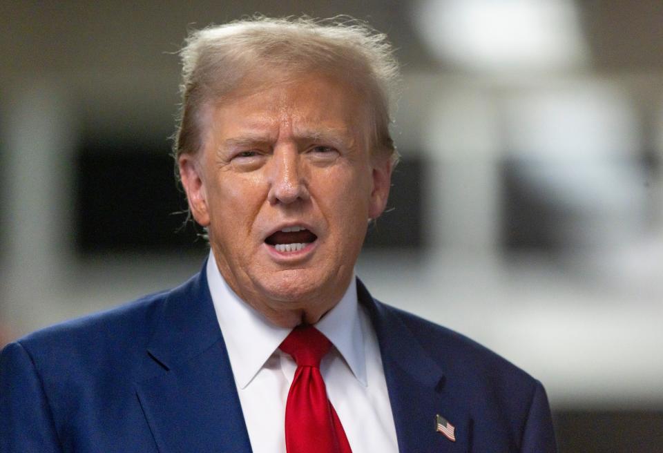 Former President Donald Trump talks to reporters as he leaves the courtroom at the end of the day in his criminal trial at New York State Supreme Court in New York on April 30.