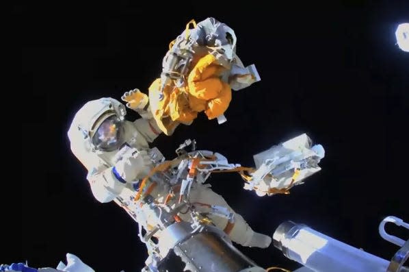 Cosmonaut in space suit on a spacewalk.