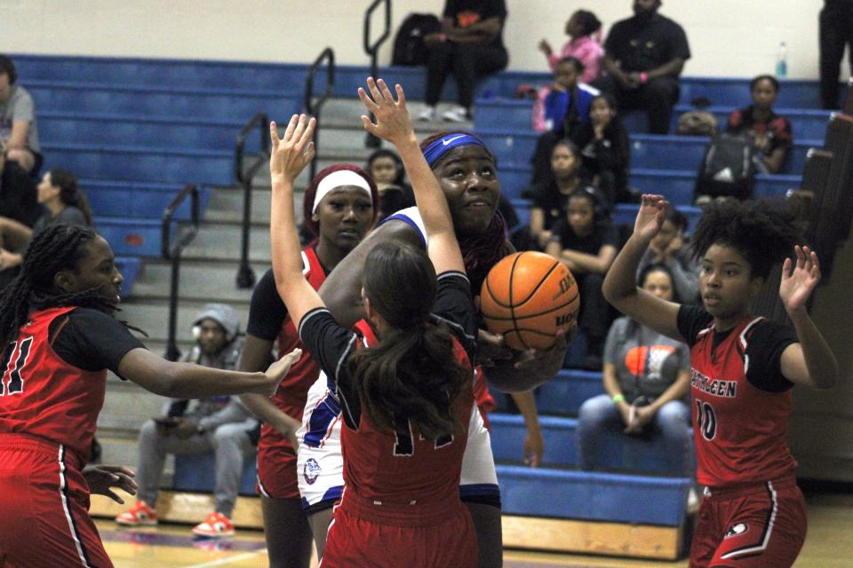 Bolles center Terrell McCoy (22) tries to find shooting room against Kathleen defenders Ashya Cave (11) and Haley Roper (14) in Monday morning's game.