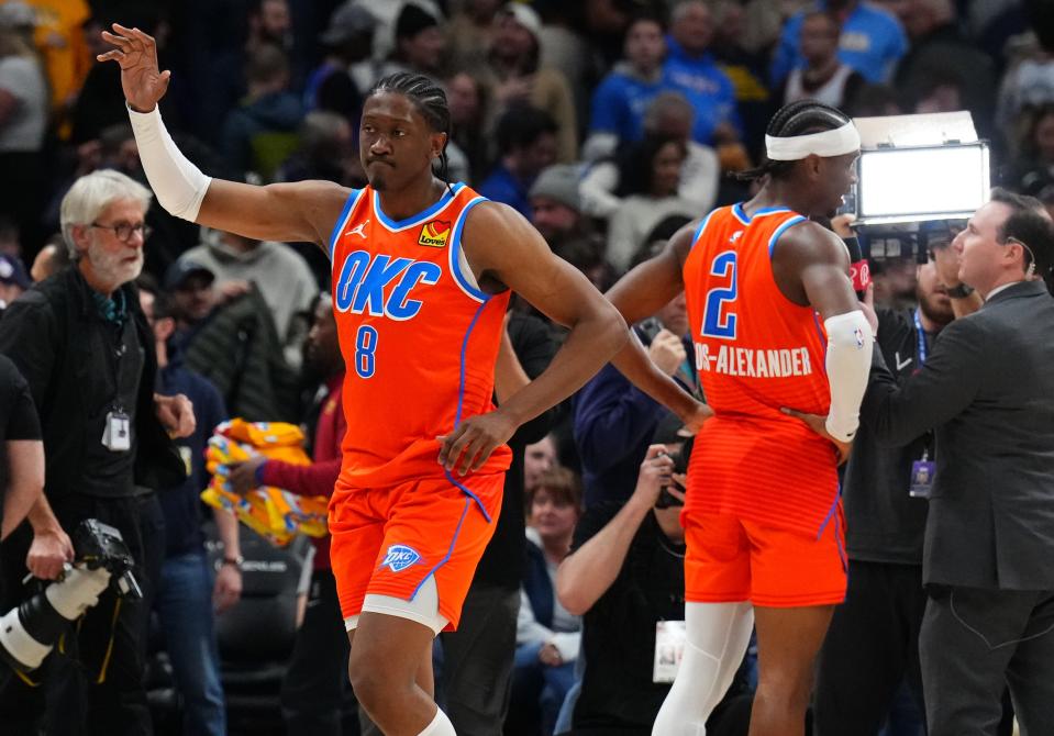 Thunder forward Jalen Williams (8) and guard Shai Gilgeous-Alexander (2) celebrate after defeating the Nuggets on Dec. 16 at Ball Arena in Denver.