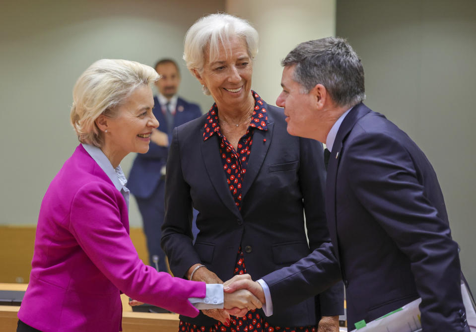 European Commission President Ursula von der Leyen, left, greets Ireland's Finance Minister Paschal Donohoe, right, during a round table meeting at an EU summit in Brussels, Friday, June 24, 2022. EU leaders were set to discuss economic topics at their summit in Brussels Friday amid inflation, high energy prices and a cost of living crisis. At center is European Central Bank President Christine Lagarde. (AP Photo/Olivier Matthys)