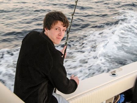 An undated handout family photo shows Witner Milner smiling as he is fishing. Milner, 25, died in the family's backyard pool in Atlanta in 2011 while breath holding to train for spear fishing. REUTERS/Hicks Milner/Handout