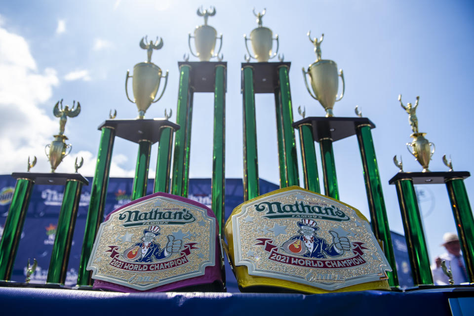 Trophies are displayed at the Nathan's Famous Fourth of July International Hot Dog-Eating Contest in Coney Island's Maimonides Park on Sunday, July 4, 2021, in New York. (AP Photo/Brittainy Newman)