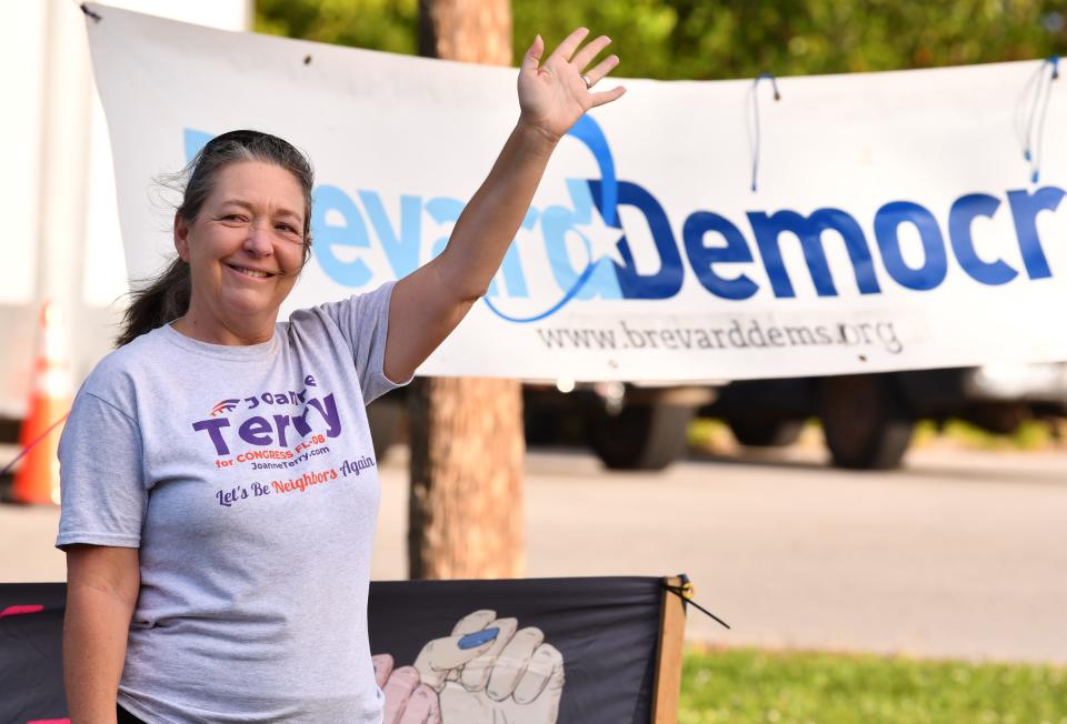 Candidate for Congress Joanne Terry waves to voters at Kiwanis Island on Merritt Island.