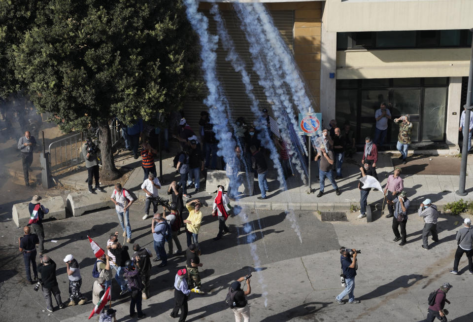 Tear gas canisters fired over retired members of the Lebanese security forces and other protesters, who were trying to advance towards government buildings during a protest demanding better pay and living conditions in Beirut, Lebanon, Tuesday April 18, 2023. Earlier in the day, Lebanon's Parliament voted to postpone municipal elections that had been planned for May 2023 in the crisis-stricken country by up to a year. (AP Photo/Hussein Malla)