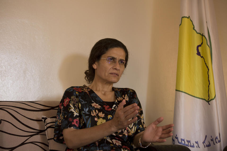 In this Tuesday, Sept. 3, 2019 photo, Ilham Ahmed, co-chair of the executive committee of the U.S-backed Syrian Democratic Council, speaks during an interview in Darbasiyah, Syria. Ahmed said Tuesday that the creation of a so-called “safe zone” in northeastern Syria is off to good start, with U.S.-backed Kurdish-led forces pulling back from an initial part of the border with Turkey, but calm can only prevail if Turkey also removes its troops. (AP Photo/Maya Alleruzzo)