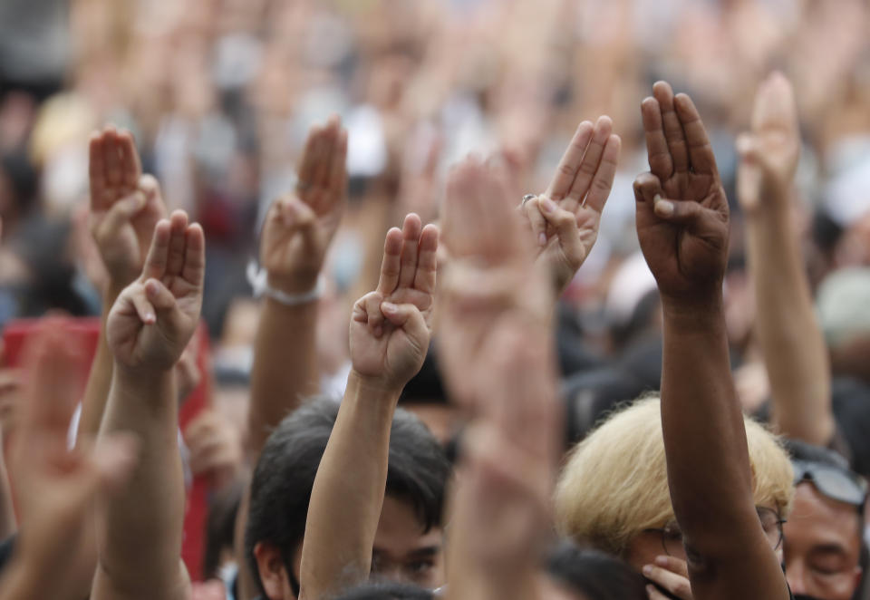 FILE - In this Oct. 15, 2020, file photo, pro-democracy demonstrators raise a three-finger salute, a symbol of resistance, as they gather at a junction in Bangkok, Thailand. Fed up with an archaic educational system and enraged by the military's efforts to keep control over their nation, a student-led campaign has shaken Thailand’s ruling establishment with the most significant campaign for political change in years. (AP Photo/Sakchai Lalit, File)