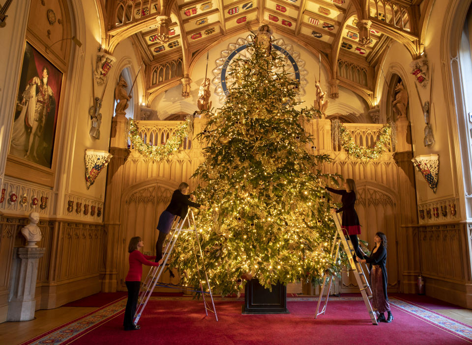 Final preparations are made to a 20ft Norman Fir Christmas tree in St George's Hall at Windsor Castle, Berkshire, which is being decorated for Christmas. (Photo by Steve Parsons/PA Images via Getty Images)