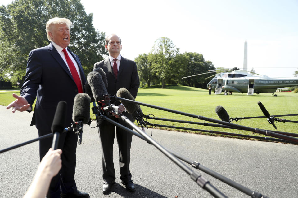 President Donald Trump speaks to members of the media with Secretary of Labor Secretary Alex Acosta on the South Lawn of the White House, Friday, July 12, 2019, before Trump boards Marine One for a short trip to Andrews Air Force Base, Md. and then on to Wisconsin. Trump says Acosta to step down, move comes in wake of handling of Jeffrey Epstein case. (AP Photo/Andrew Harnik)