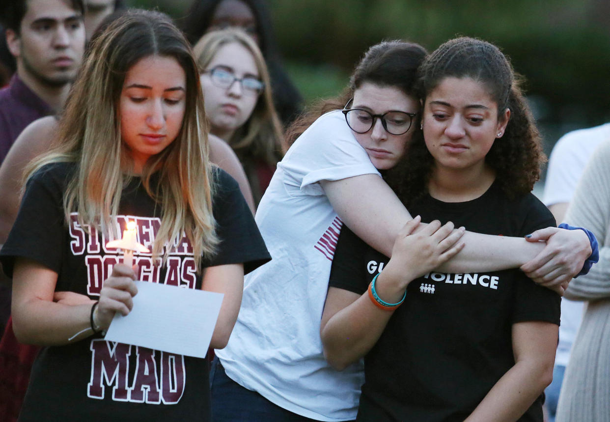 Students grieve during a candlelight vigil in commemoration of the one-year anniversary of the mass shooting at Marjory Stoneman Douglas High School. The federal government and some state legislatures have pushed for enhanced security at schools in the wake of the shooting.&nbsp; &nbsp; (Photo: Orlando Sentinel via Getty Images)