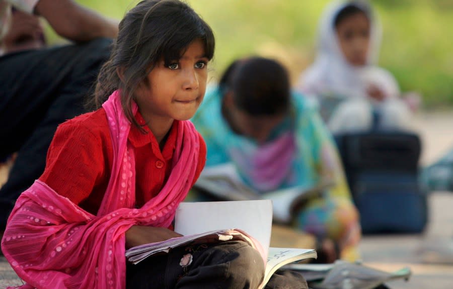 A Pakistani girl attends a makeshift class held at a park and organized by volunteers on International Literacy Day, in Islamabad, Pakistan, Tuesday, Sept. 8, 2009. According to UNICEF, 56 percent of Pakistani children attend primary school, and 55 percent of adults are literate. (AP Photo/Anjum Naveed)