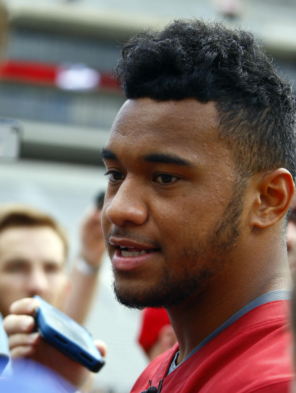 Alabama quarterback Tua Tagovailoa (13) speaks to media before a NCAA college football practice, Saturday, Aug. 4, 2018, in Tuscaloosa, Ala. (AP Photo/Butch Dill)