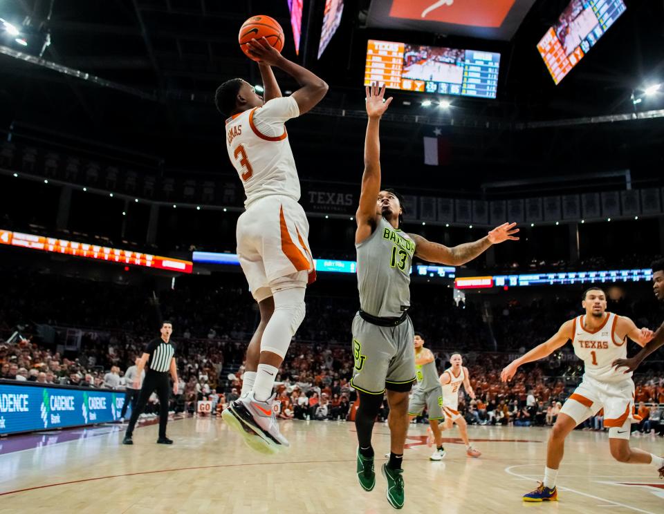 Texas guard Max Abmas shoots over Baylor guard Langston Love during the Longhorns' 75-73 win on Saturday.