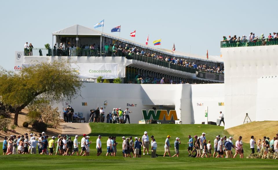 Feb 12, 2022; Scottsdale Arizona, USA; Fans make their way past the fairway of hole 17 during Round 3 at the WM Phoenix Open. Mandatory Credit: Patrick Breen-The Republic