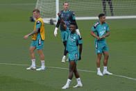 Real Madrid's Vinicius Junior, centre, raises his arm during a Media Opening day training session in Madrid, Spain, Tuesday, May 24, 2022. Real Madrid will play Liverpool in Saturday's Champions League soccer final in Paris. (AP Photo/Manu Fernandez)