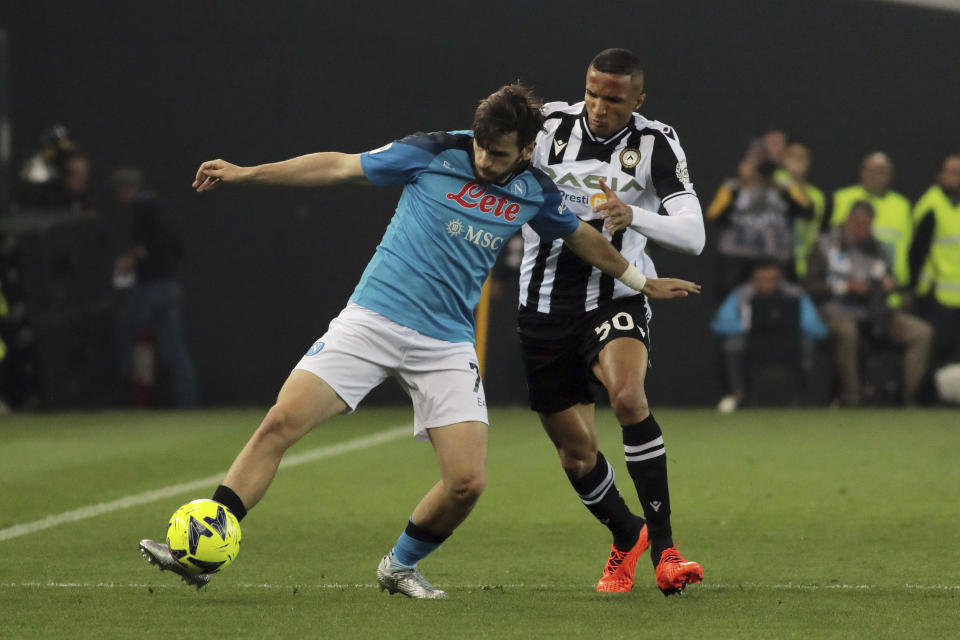 Udinese Rodrigo Becao, right, and Napoli's Khvicha Kvaratskhelia battle for the ball during the Serie A soccer match between Udinese and Napoli at the Dacia Arena in Udine, Italy, Thursday, May 4, 2023. (Andrea Bressanutti/LaPresse via AP)