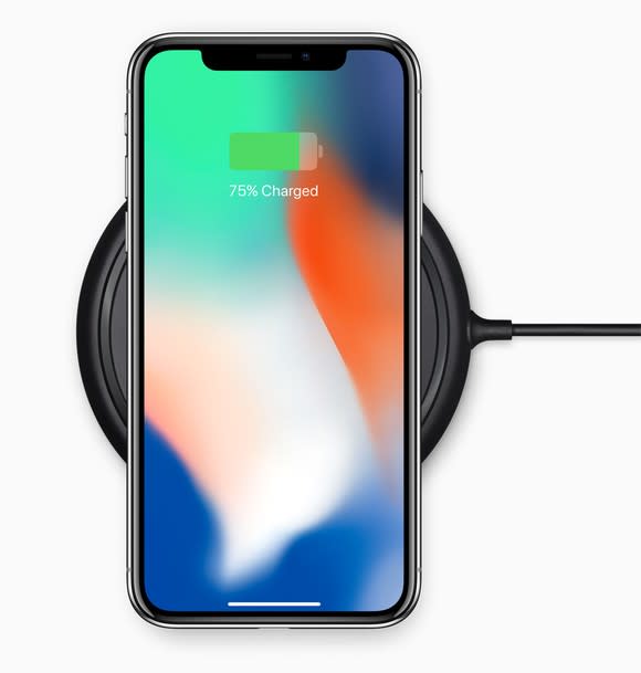 iPhone X on a wireless charging dock.