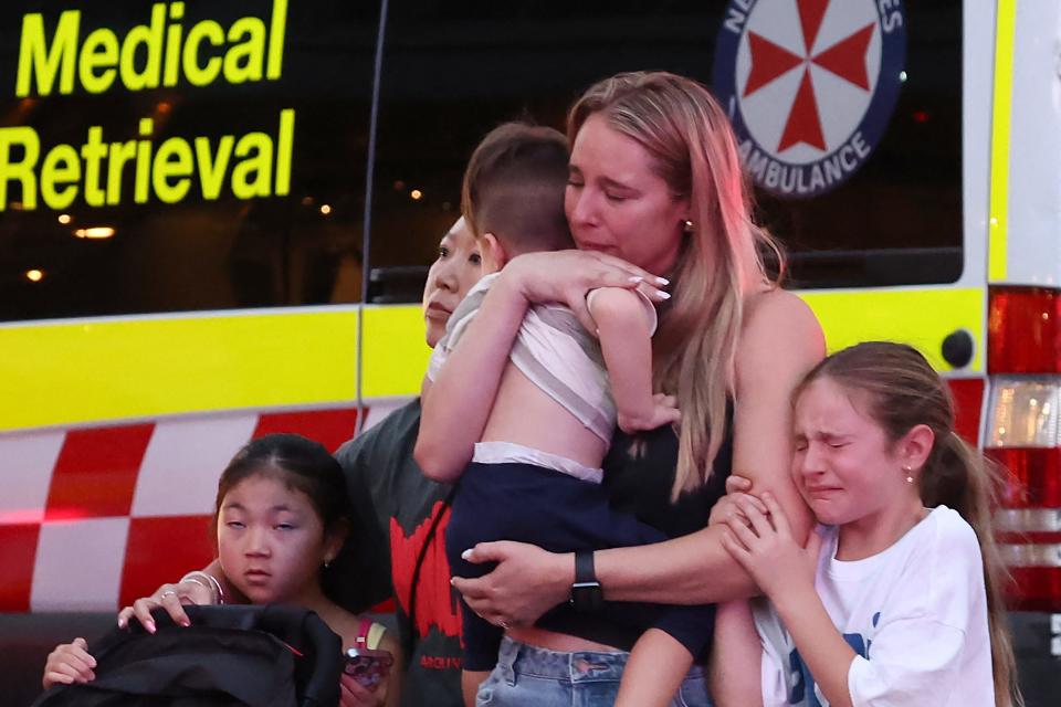 A family leaves the Westfield Bondi Junction shopping mall after a stabbing incident in Sydney, Australia, on April 13, 2024.