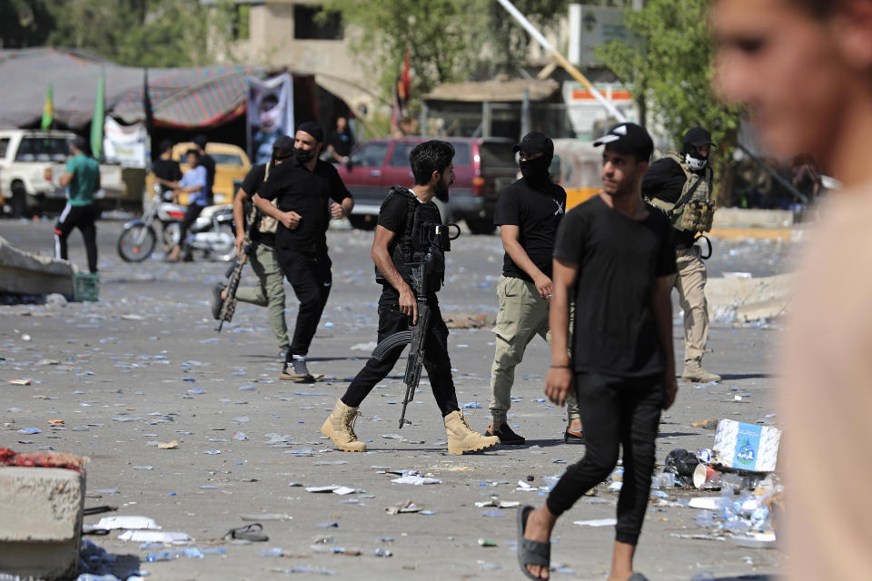 Fighters from the Saraya Salam (Peace Brigades) loyal to influential Shiite Iraqi cleric Muqtada al-Sadr deploy in Baghdad, Iraq, Tuesday, Aug. 30, 2022. Al-Sadr has called on his supporters to withdraw from the capital's government quarter. His supporters have traded heavy fire with security forces there in a serious escalation of a months-long political crisis gripping the nation. (AP Photo/Murtadha Ridha)