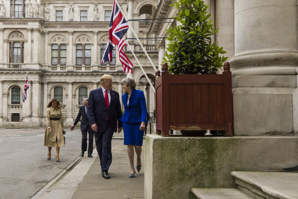 President Donald Trump walks with British Prime Minister Theresa May, followed by first lady Melania Trump, and Philip May, to a news conference at the Foreign Office, Tuesday, June 4, 2019, in central London. (AP Photo/Alex Brandon)