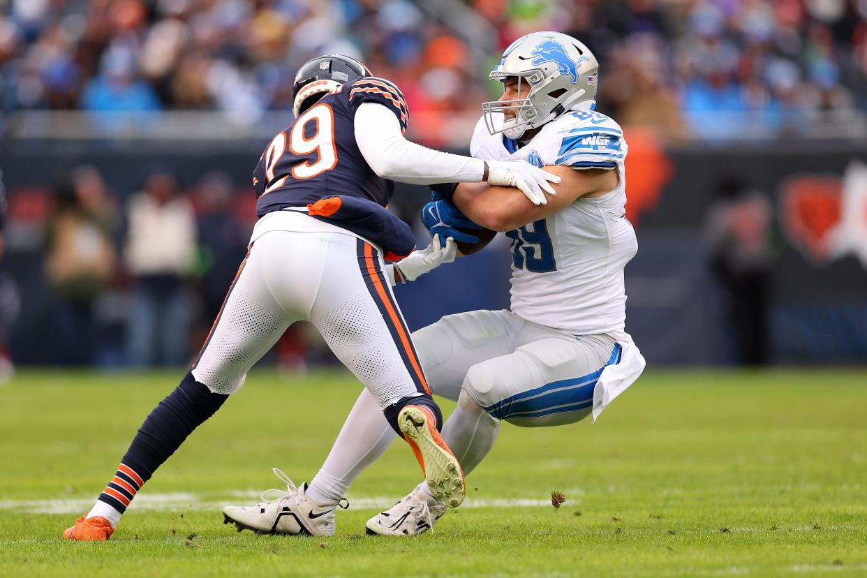 Lions tight end Brock Wright is tackled by Bears defensive back Tyrique Stevenson during the second quarter on Sunday, Dec. 10, 2023, in Chicago.