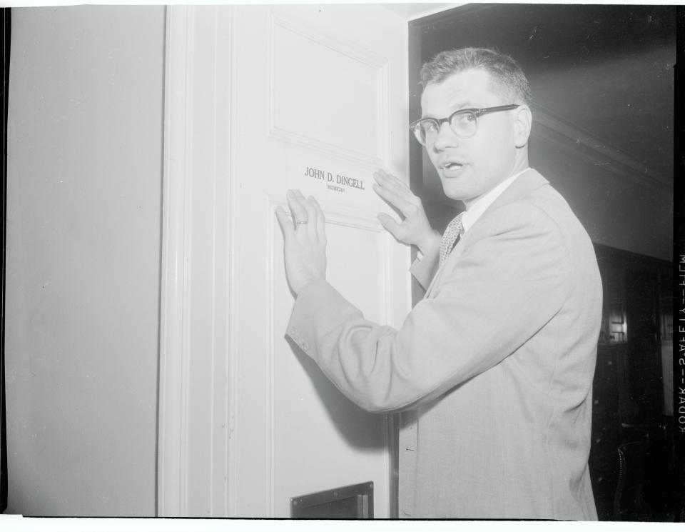 Dingell, then the youngest member of the House of Representatives, is shown as he takes&nbsp;over his father's quarters in the House office building, name plate and all.