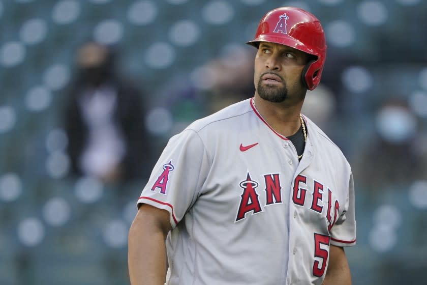 Los Angeles Angels' Albert Pujols walks to the dugout during a baseball game against the Seattle Mariners.