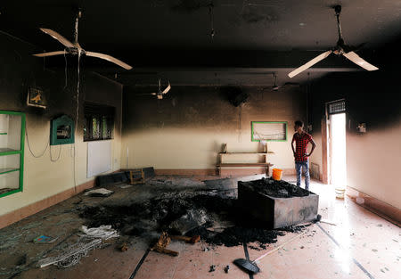 A Muslim man looks at damage inside a mosque after a mob attack in Kottampitiya, Sri Lanka May 14. REUTERS/Dinuka Liyanawatte