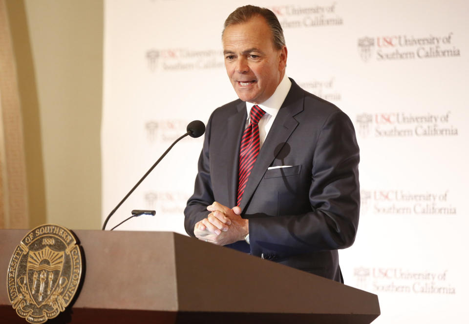 Rick Caruso, chairman of the University of Southern California Board of Trustees announces Carol Folt as the USC's 12th president in Los Angeles Wednesday, March 20, 2019. The announcement comes a week after news broke of a massive college bribery scandal involving USC and other universities across the country. She will take office as USC's new president on July 1. (AP Photo/Damian Dovarganes)