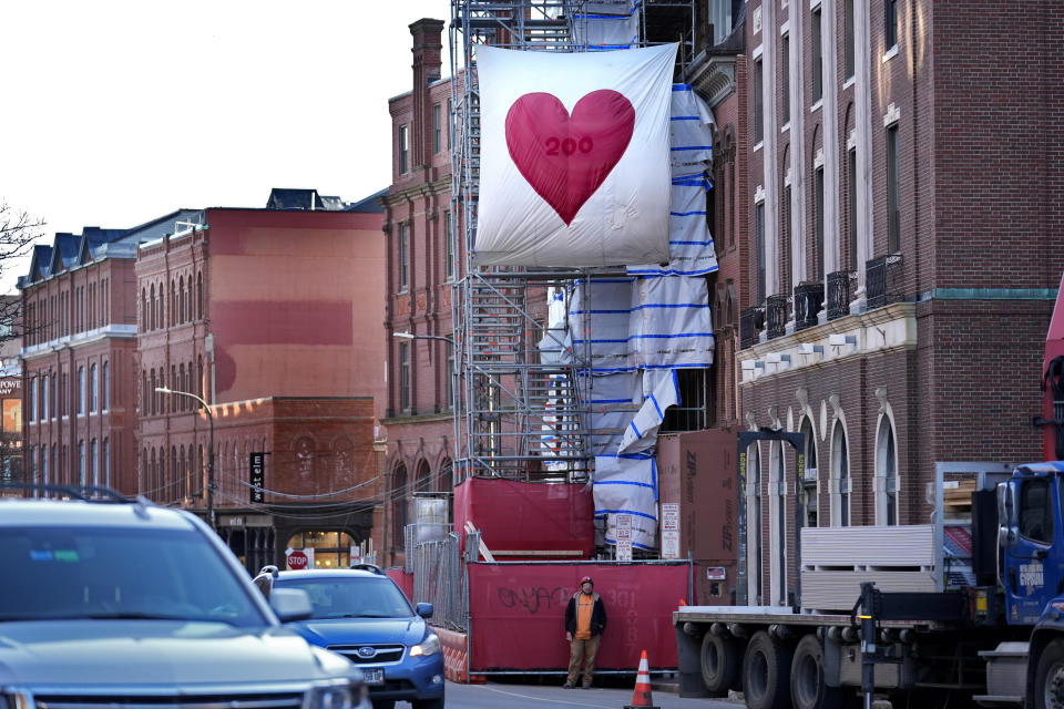 A Valentine's Day heart hangs on scaffolding, Wednesday, Feb. 14, 2024, in Portland, Maine. The public has helped honor the memory of Kevin Fahrman, the Valentine's Day Bandit who secretly hung hundreds of red paper hearts throughout the city every February 14th. Farman died last year. (AP Photo/Robert F. Bukaty)