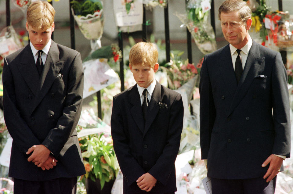 Prince Charles (R), Prince Harry (C) and Prince William look at the coffin of Diana, Princess of Wales, after it was placed into a hearse September 6. Hundreds of thousands of mourners lined the streets of Central London to watch the funeral procession. The Princess died last week in a car crash in Paris.