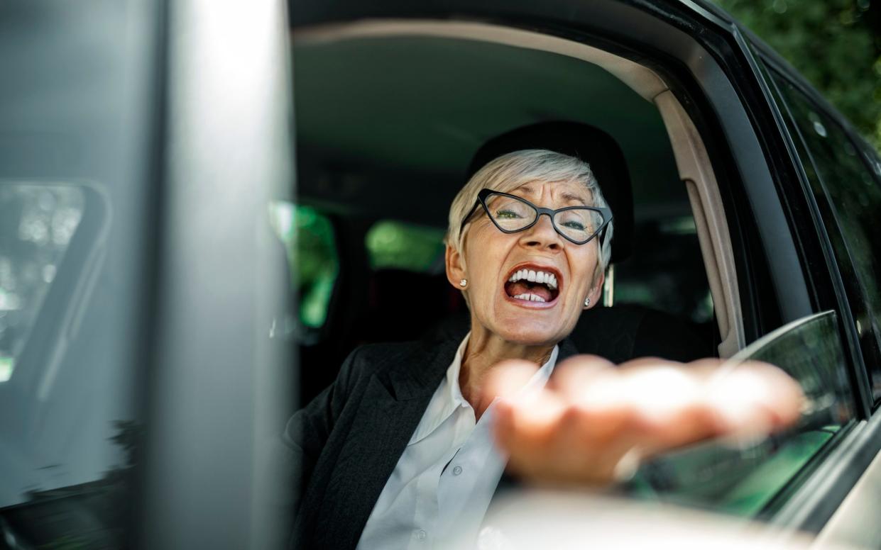 Older, angry woman shouting