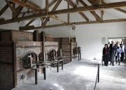 <p>U.S. Vice President Mike Pence, second from right, his wife Karen and their daugher Charlotte, right, walk through the former crematories during a visit to the former Nazi concentration camp in Dachau near Munich, southern Germany, Feb. 19, 2017, one day after he attended the Munich Security Conference. (Photo: Matthias Schrader/AP) </p>